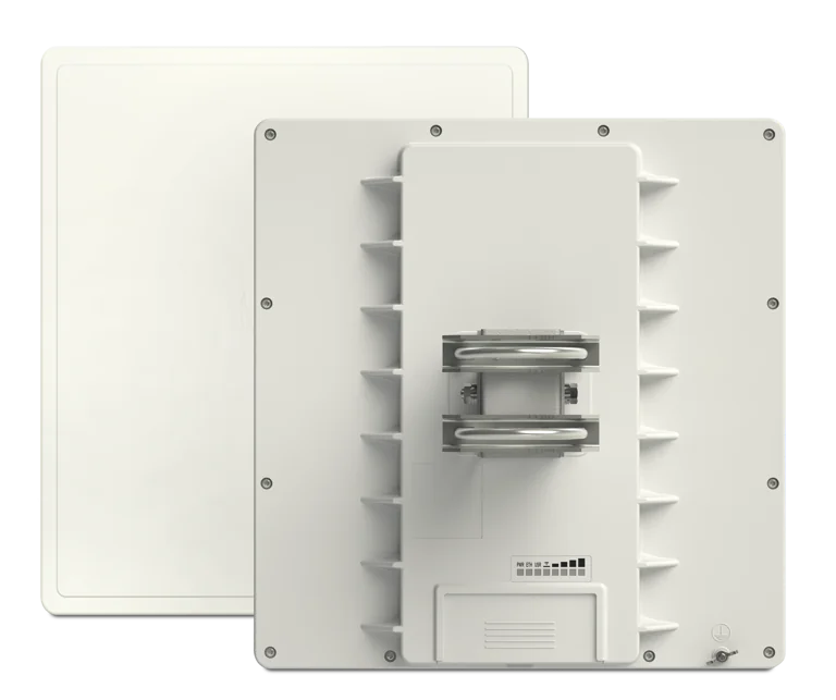 Rear view of a large industrial inverter with cooling fins and bus bars visible on a light panel core.